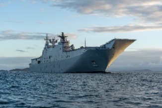 Image of a ship with a helicopter dock at sea