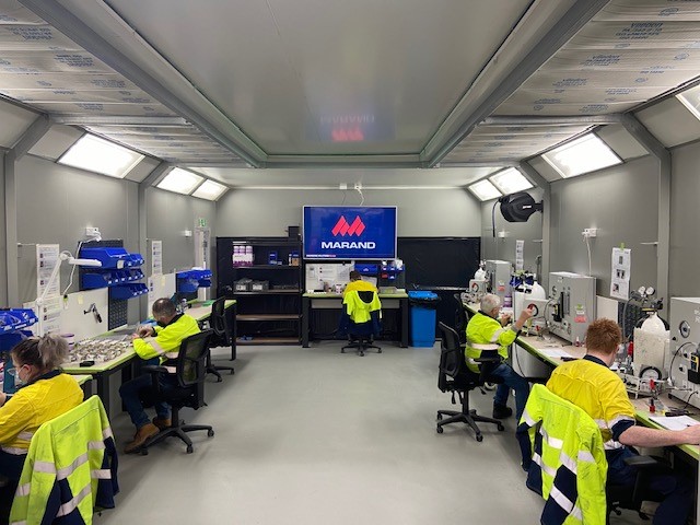 People in high visibility clothing in a laboratory